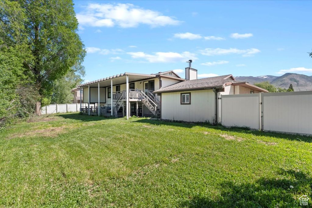 Rear view of property featuring stairway, a gate, and a mountain view