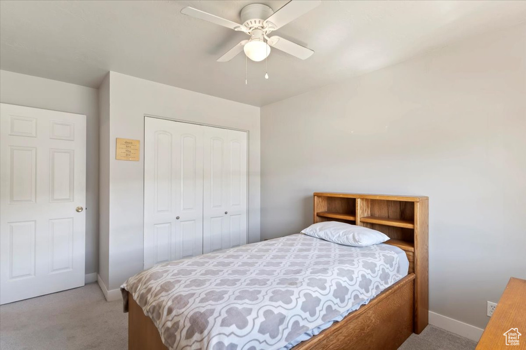 Bedroom with carpet flooring, a closet, and baseboards