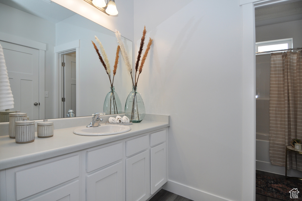 Full bathroom featuring vanity and baseboards