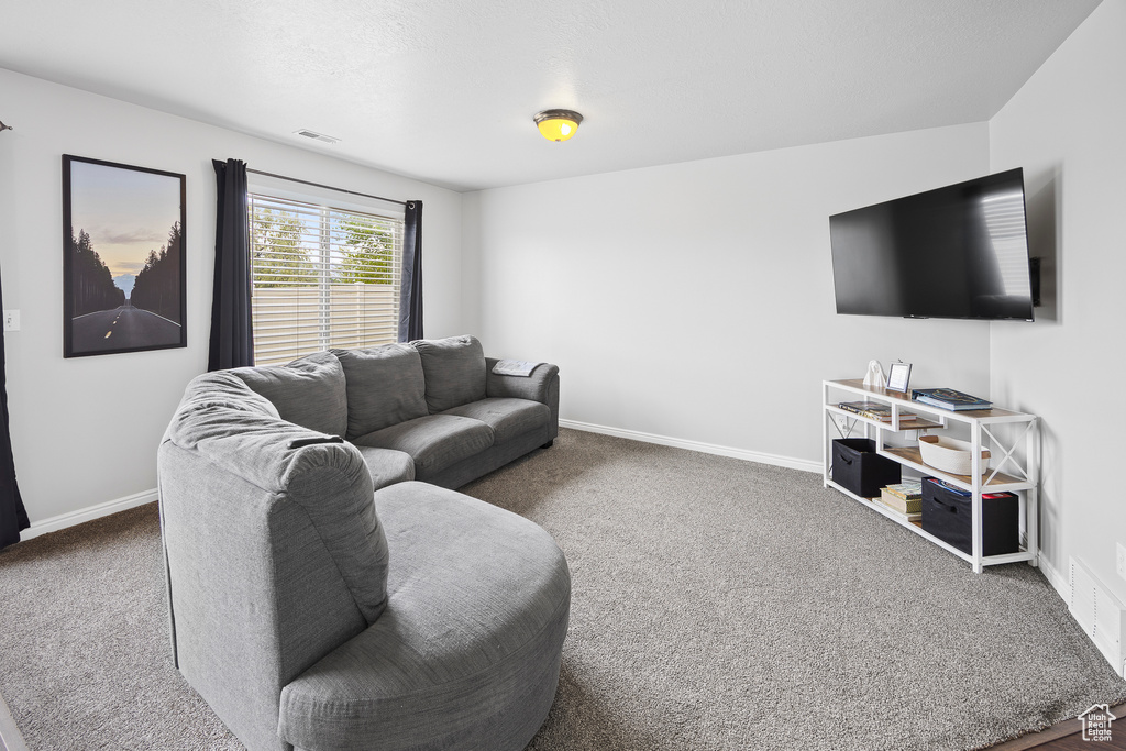 Living area with carpet and baseboards