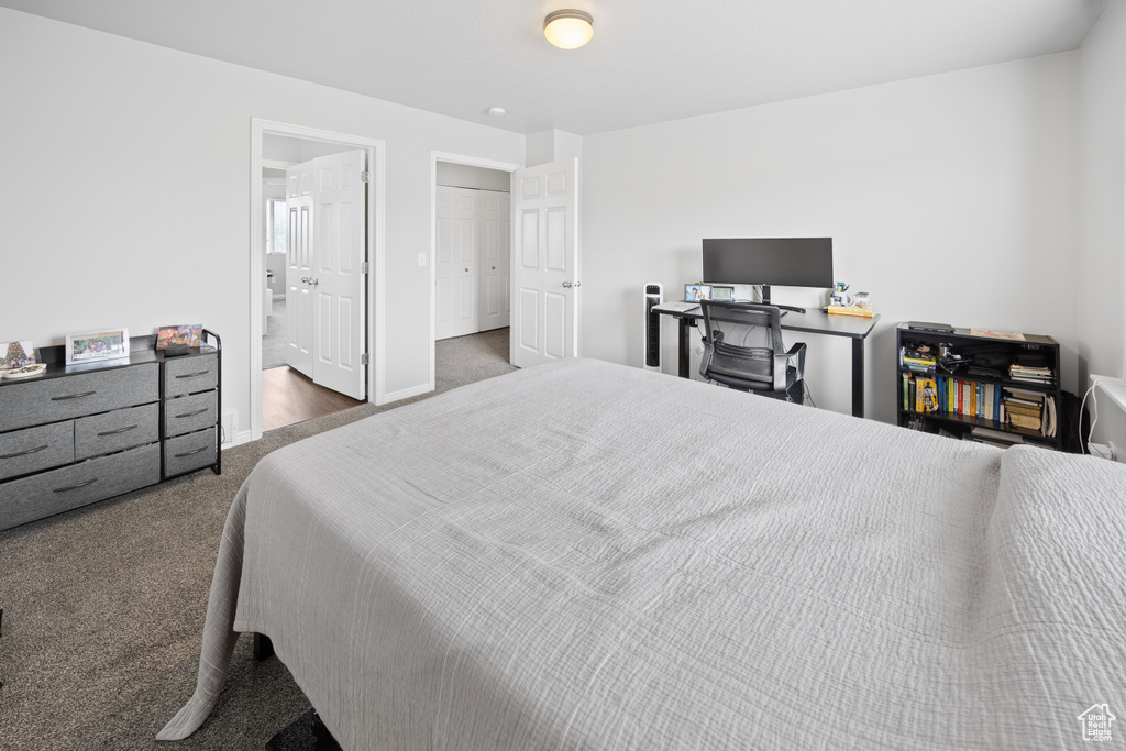 Bedroom with carpet floors, connected bathroom, and baseboards