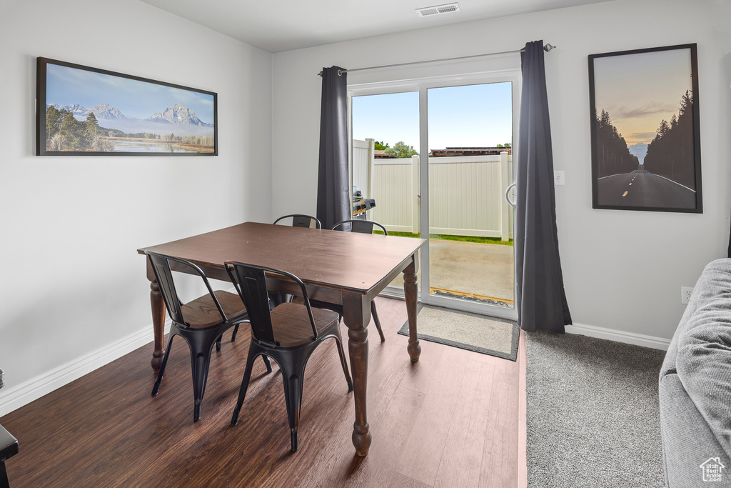 Dining area with baseboards and wood finished floors