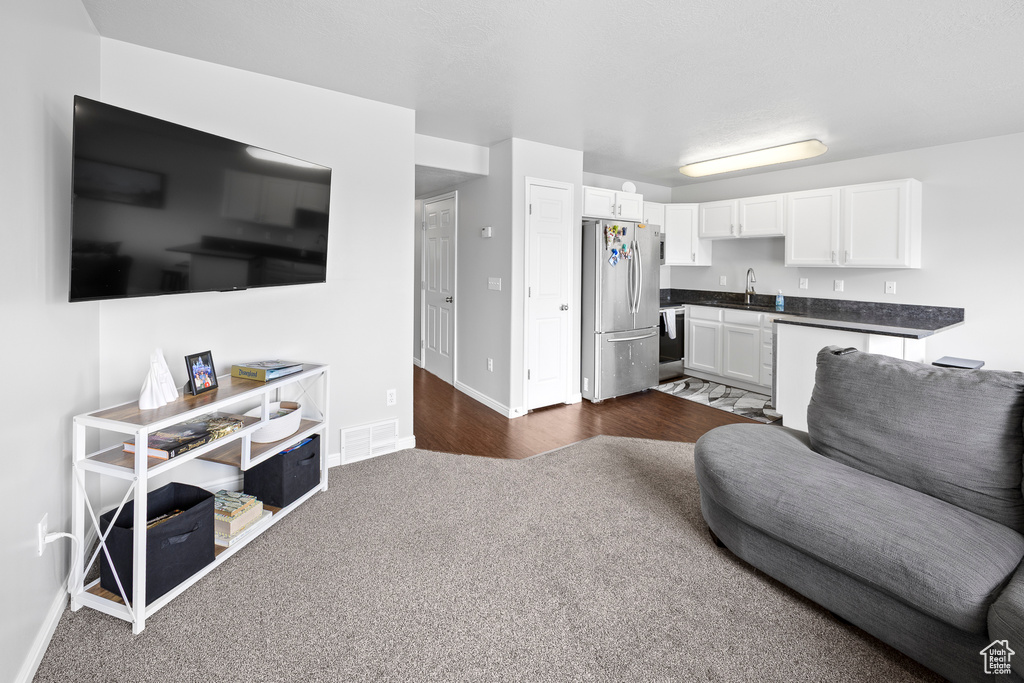 Living room with baseboards and dark carpet