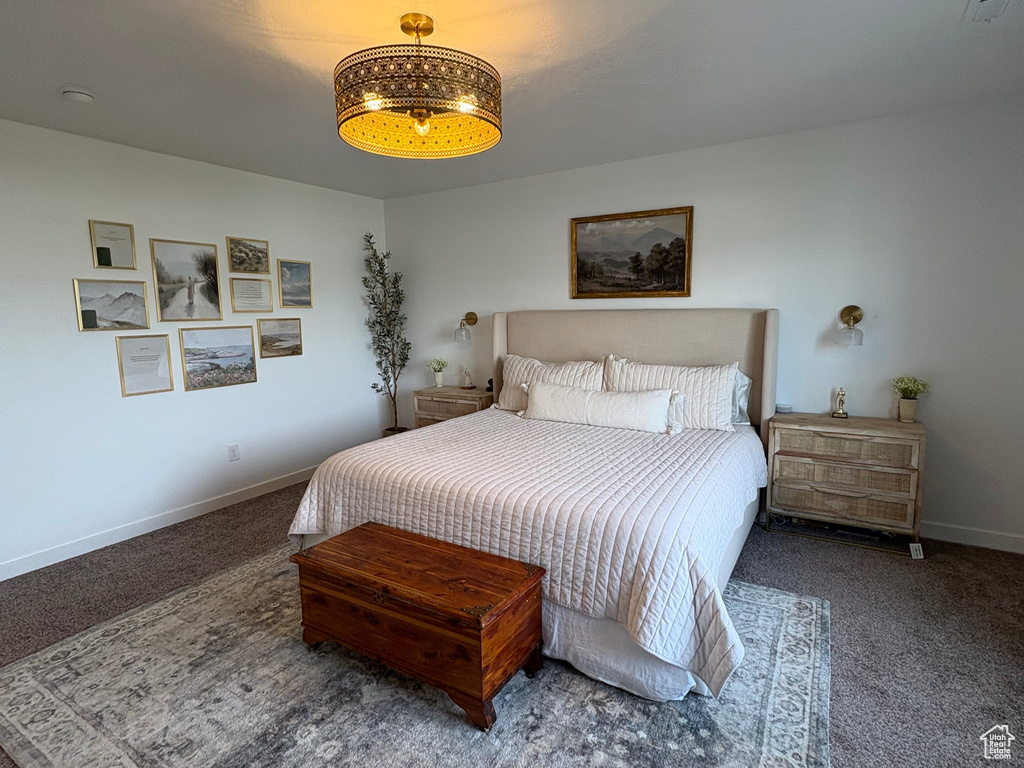 Carpeted bedroom with a textured ceiling and baseboards