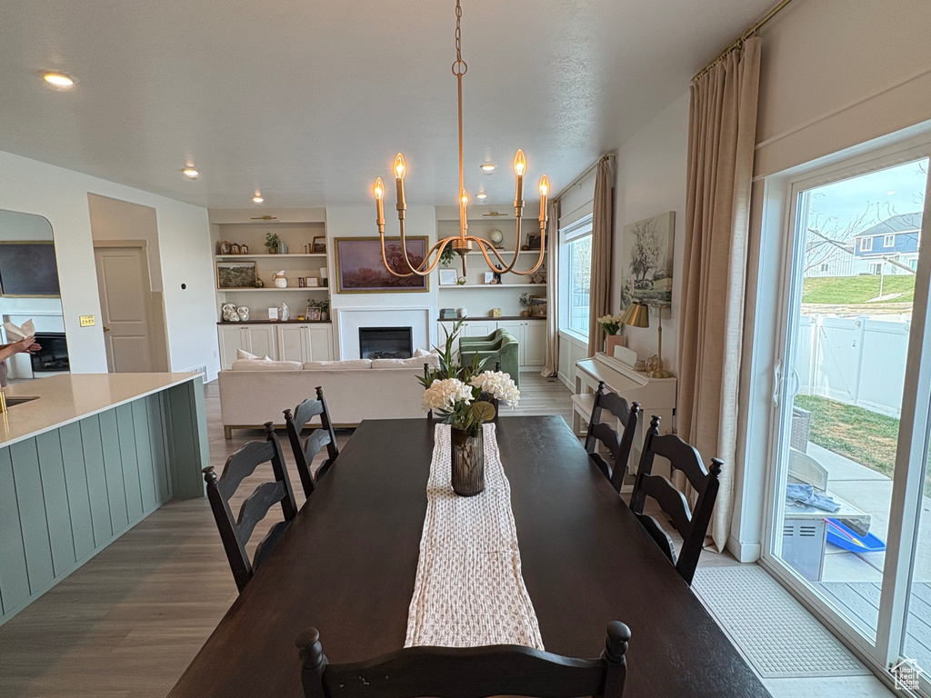 Dining area with a chandelier and light wood-style floors