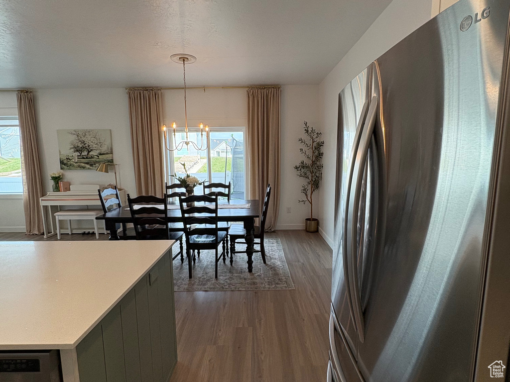 Kitchen featuring stainless steel appliances, dark wood finished floors, plenty of natural light, and light countertops