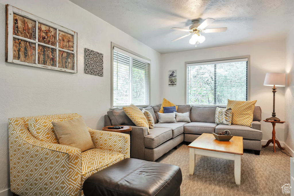 Living room with a ceiling fan and baseboards
