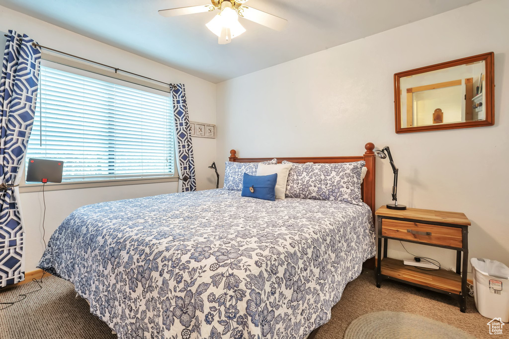 Carpeted bedroom with ceiling fan