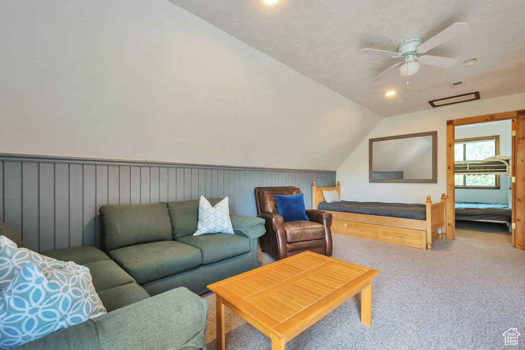Living area featuring light colored carpet, lofted ceiling, recessed lighting, and ceiling fan