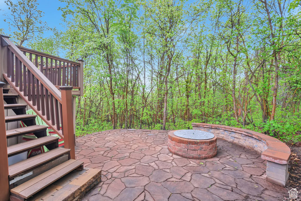 View of patio / terrace featuring stairs and a fire pit