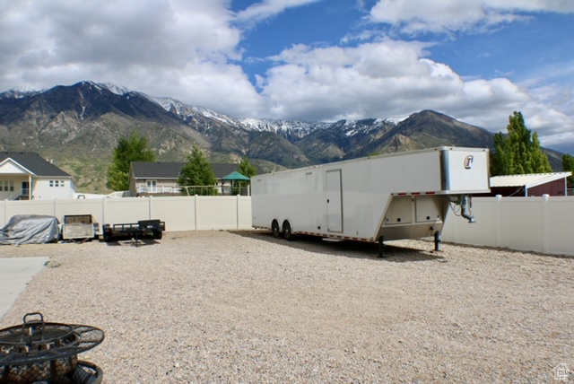 View of yard with a mountain view and fence