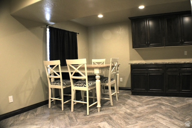 Dining area with baseboards and recessed lighting