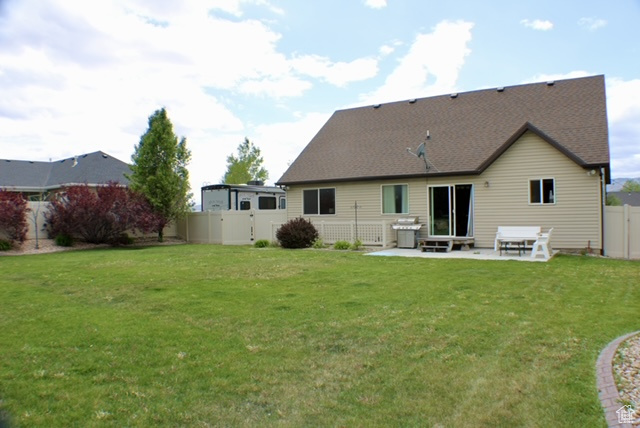 Rear view of property with a patio and a gate