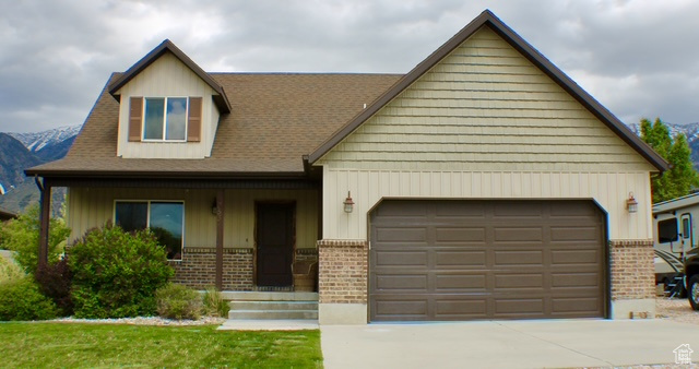 View of front of house featuring brick siding, an attached garage, and concrete driveway