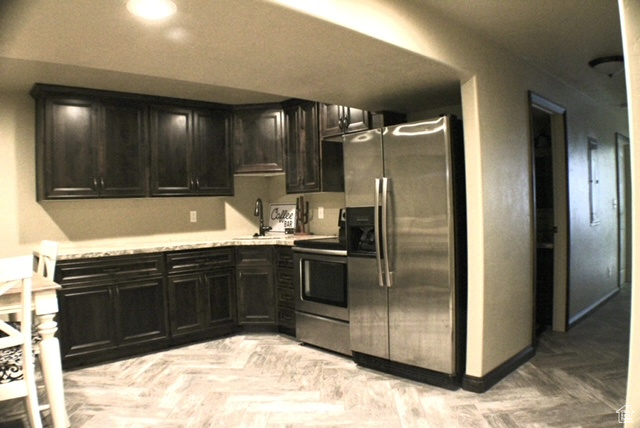 Kitchen with stainless steel appliances, a sink, and light countertops