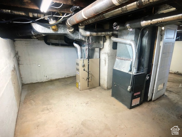 Unfinished below grade area with heating unit