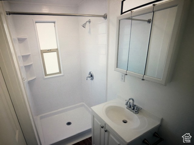 Full bathroom with vanity and a stall shower