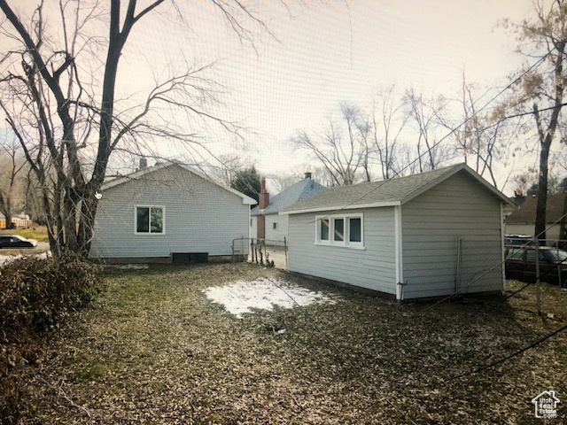 Back of house with fence