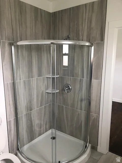 Full bath with a stall shower and toilet
