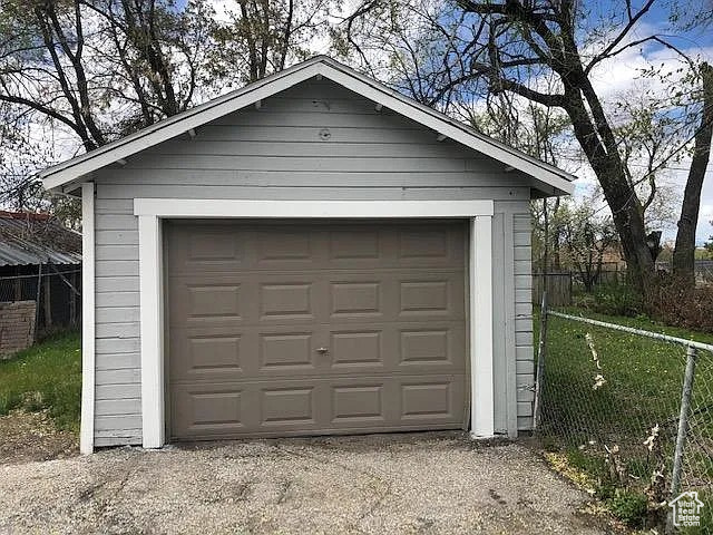 Detached garage featuring fence