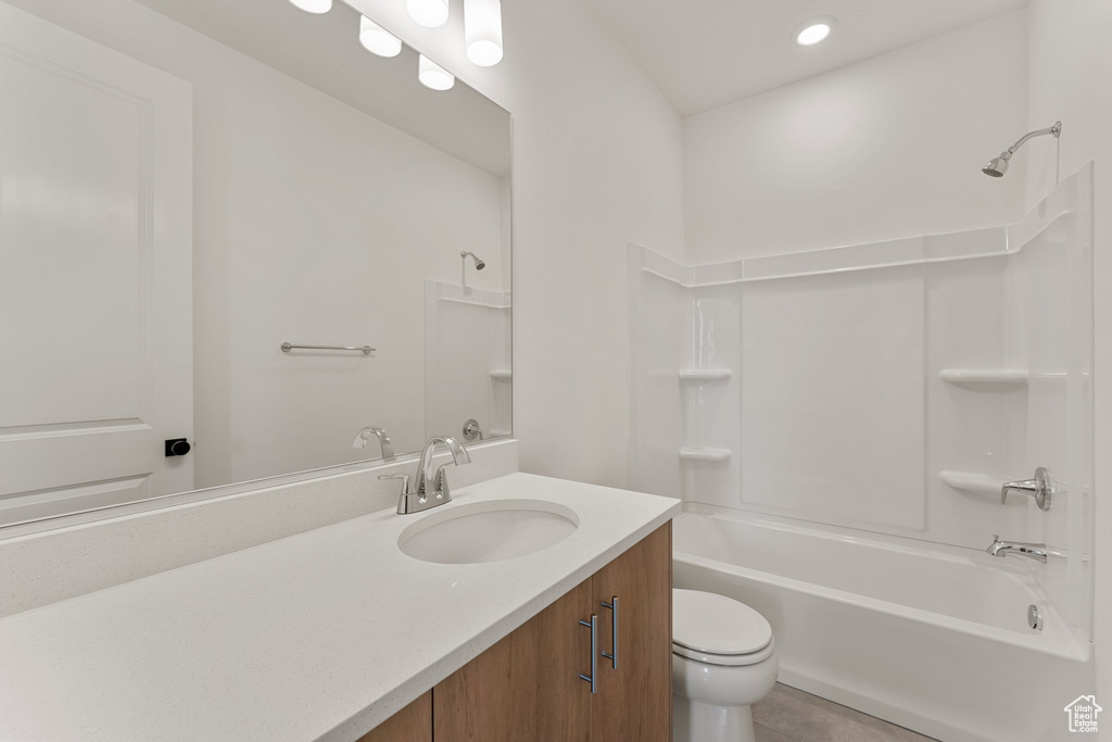Bathroom featuring toilet, bathing tub / shower combination, vanity, tile patterned floors, and recessed lighting