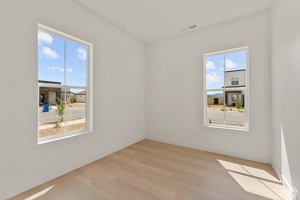 Unfurnished room featuring light wood-style floors and baseboards
