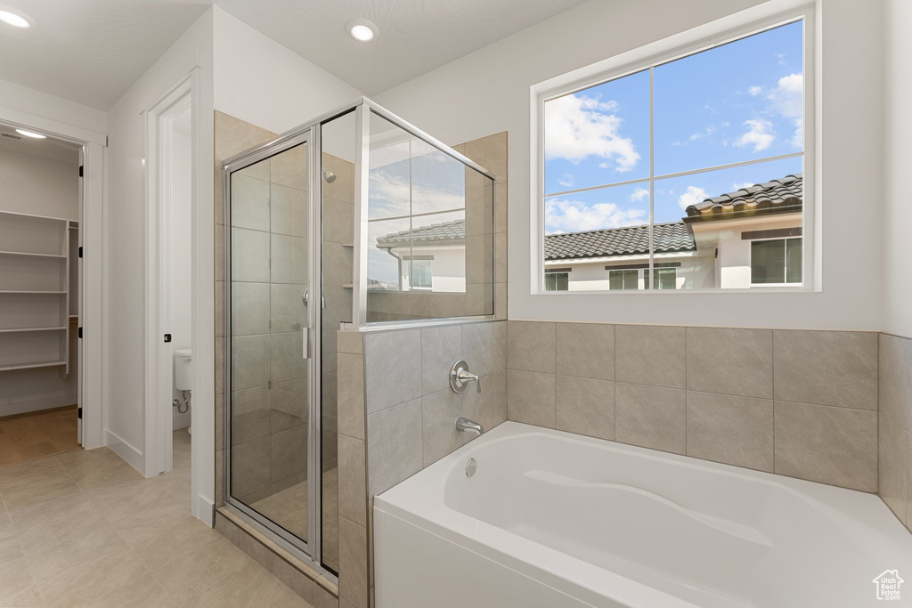 Full bathroom with a stall shower, a garden tub, toilet, recessed lighting, and tile patterned floors