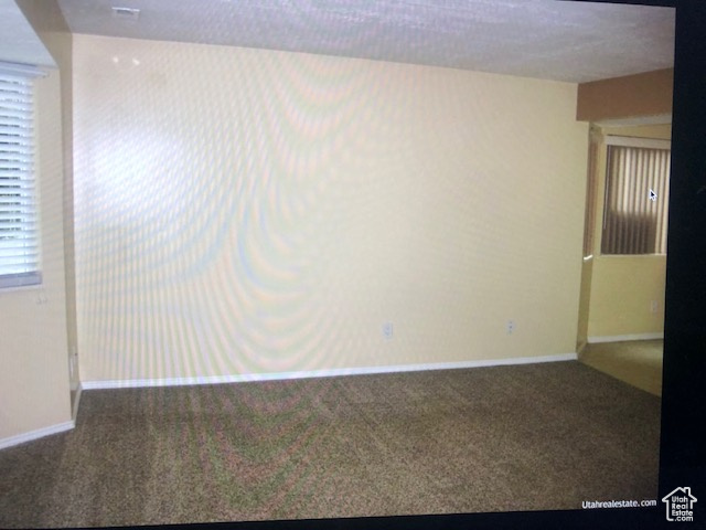 Unfurnished room with carpet floors and baseboards