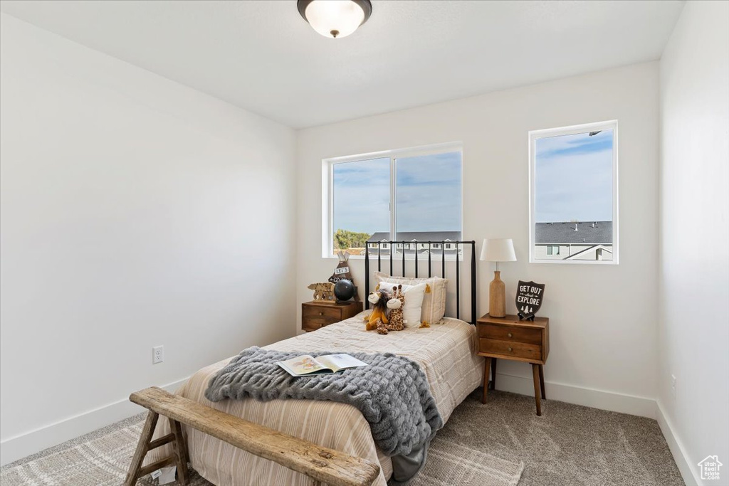 Carpeted bedroom with baseboards