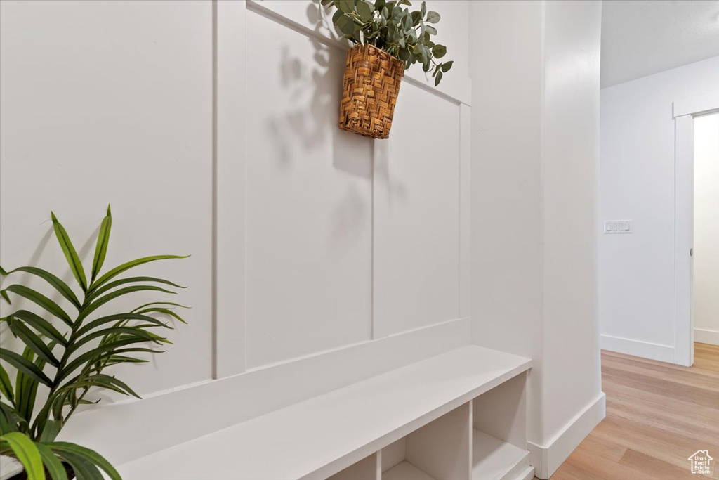 Mudroom with baseboards and light wood-style flooring