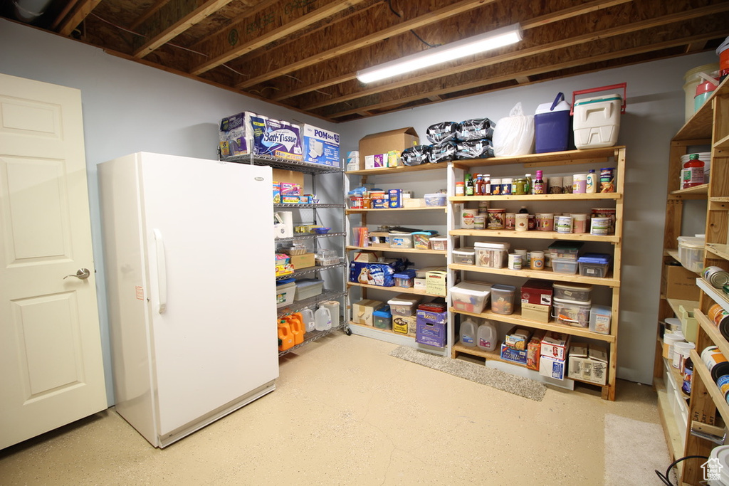 Finished below grade area featuring freestanding refrigerator