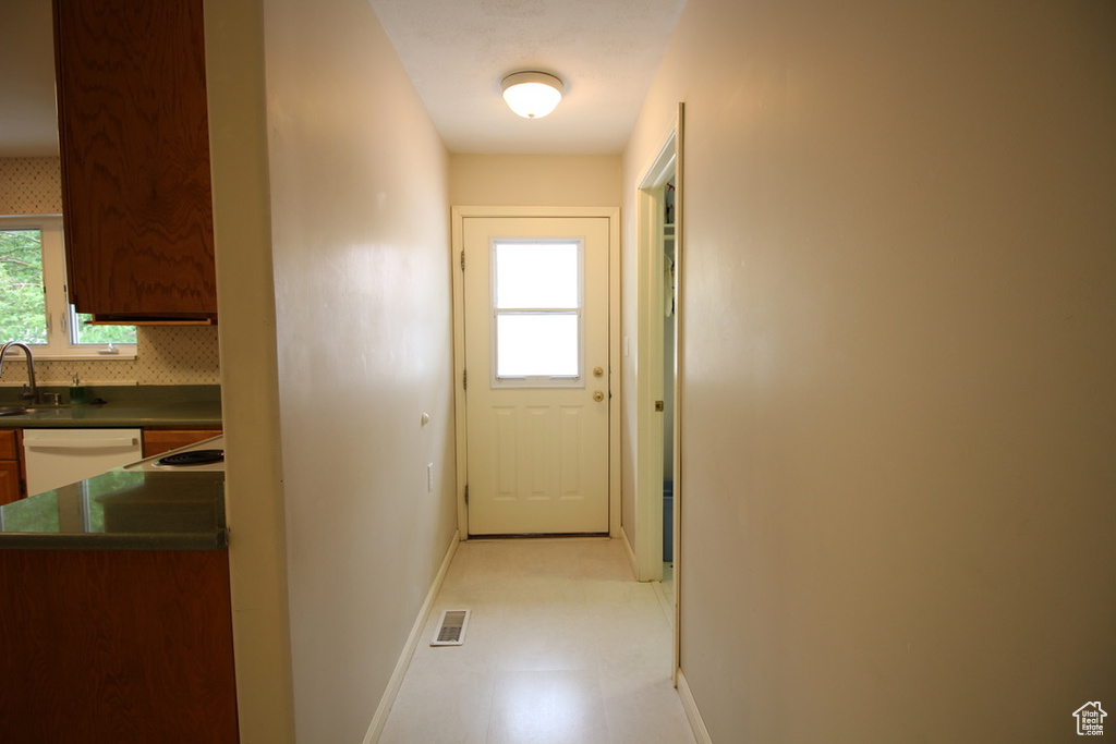 Hall with baseboards and light flooring
