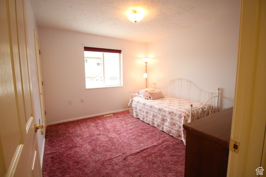 Carpeted bedroom with baseboards