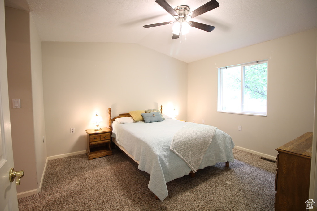 Bedroom featuring baseboards, carpet, lofted ceiling, and a ceiling fan