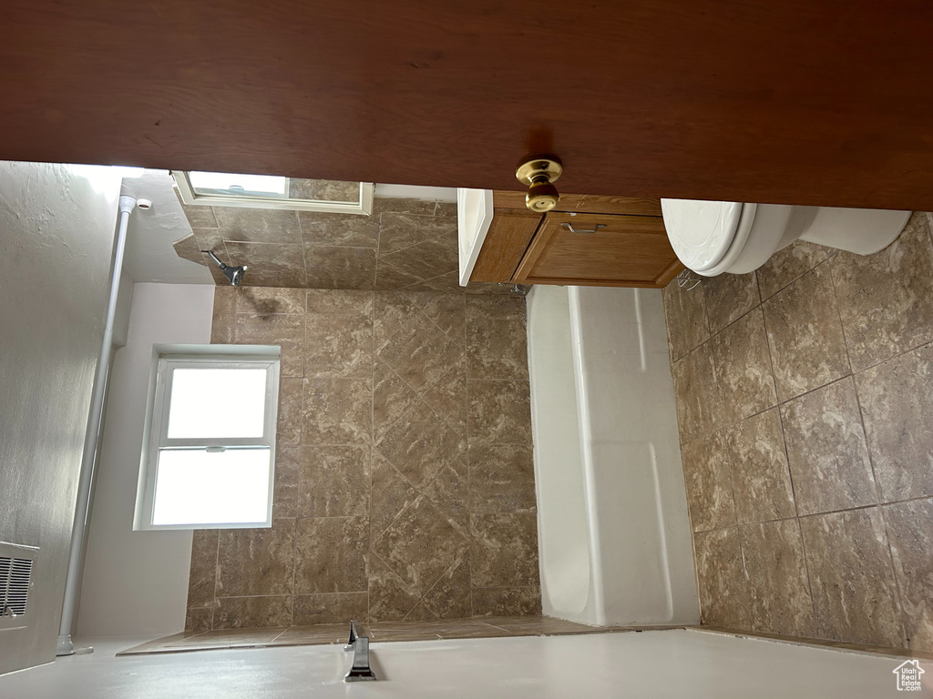 Full bathroom featuring toilet, shower / washtub combination, and vanity