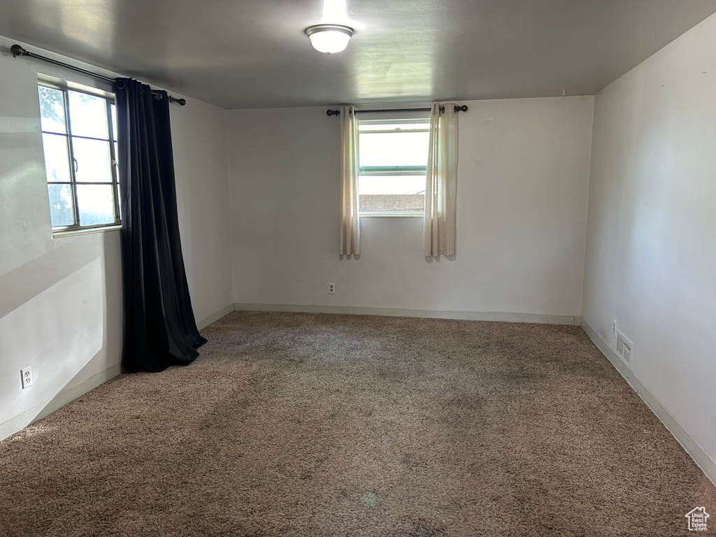 Unfurnished room with light carpet and baseboards