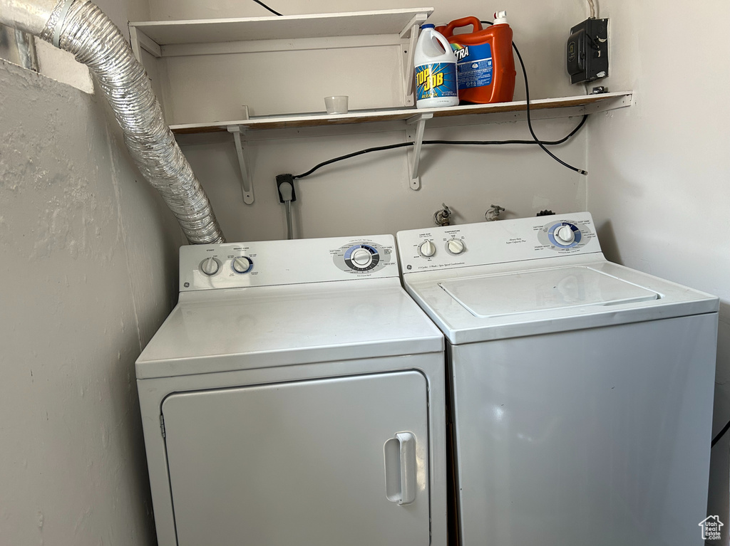 Clothes washing area featuring separate washer and dryer