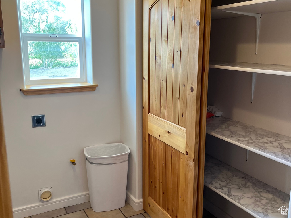 Bathroom featuring baseboards and tile patterned flooring