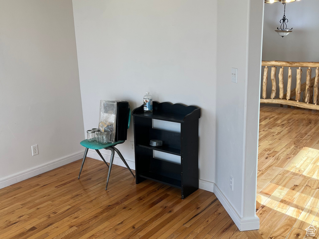 Unfurnished room featuring hardwood / wood-style floors and baseboards