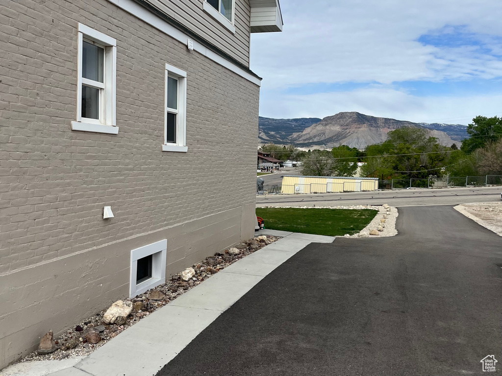 View of side of home featuring a mountain view and brick siding