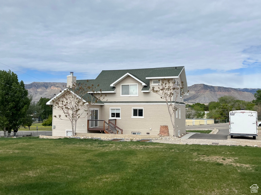 Rear view of house with a chimney and a mountain view