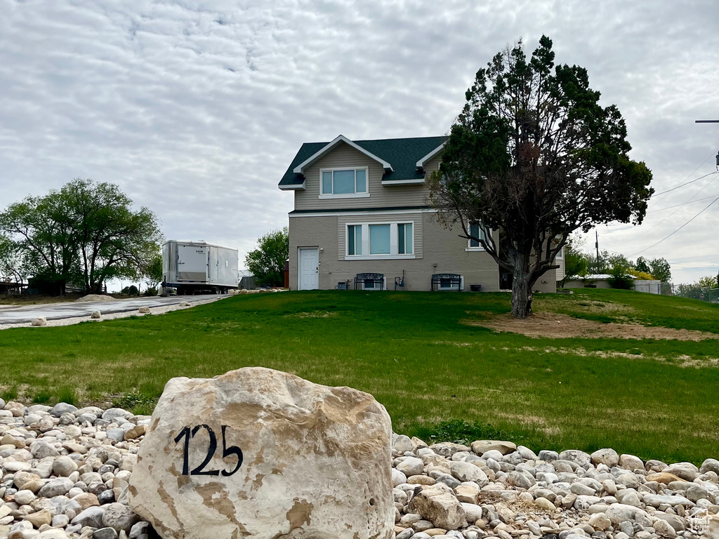 View of home\'s exterior featuring a lawn and an attached garage