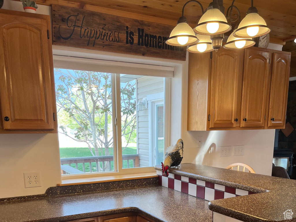 Kitchen featuring dark countertops, healthy amount of natural light, and pendant lighting