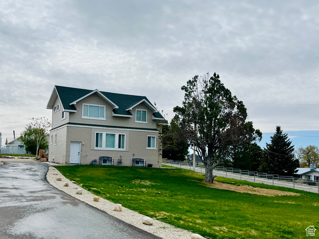 View of property exterior featuring asphalt driveway