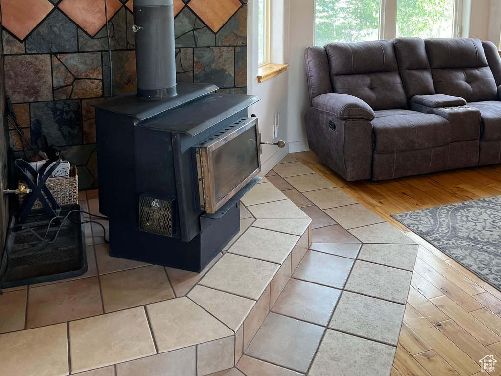 Living area featuring a wood stove and wood finished floors