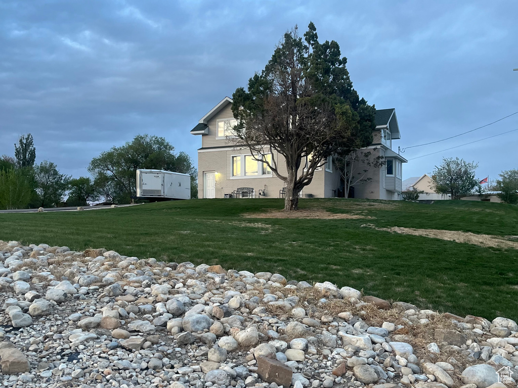 View of side of property with a yard