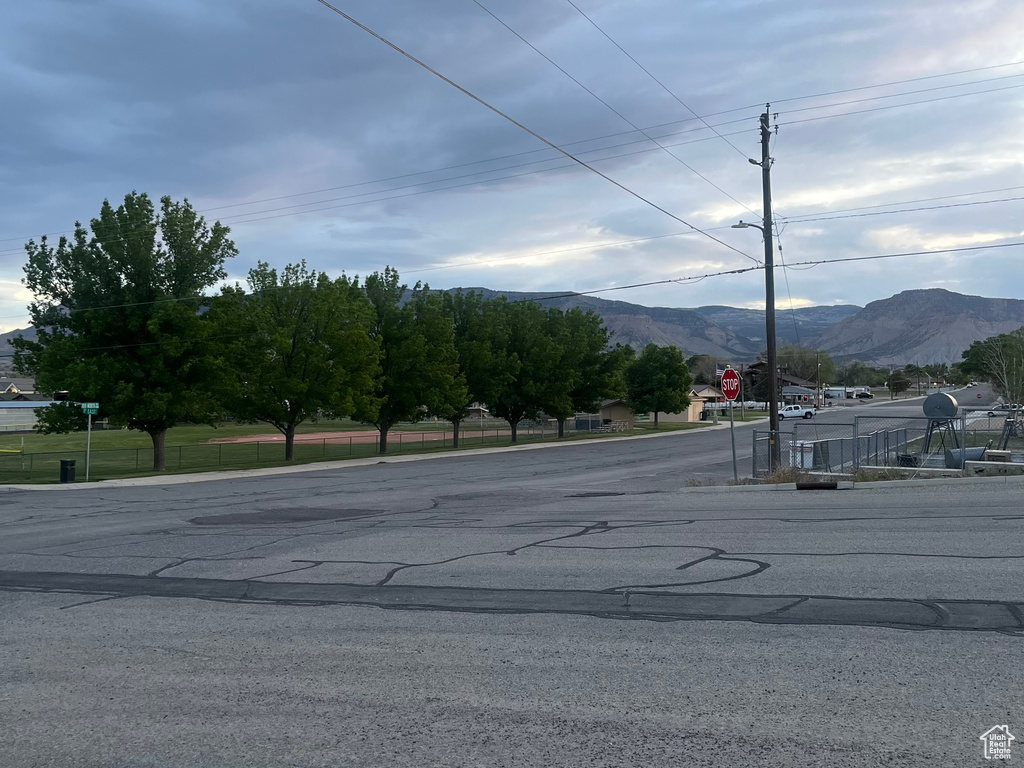 View of asphalt street with traffic signs and a mountain view