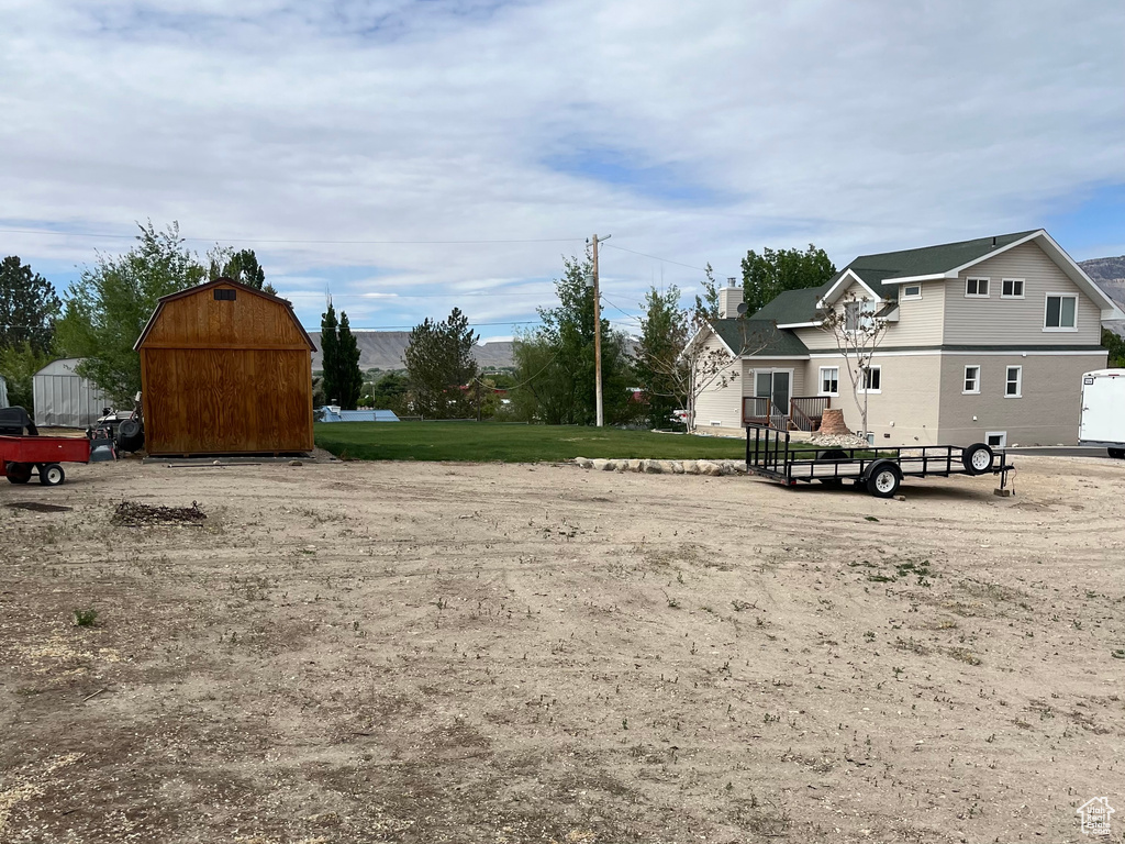 View of yard featuring an outbuilding and a shed