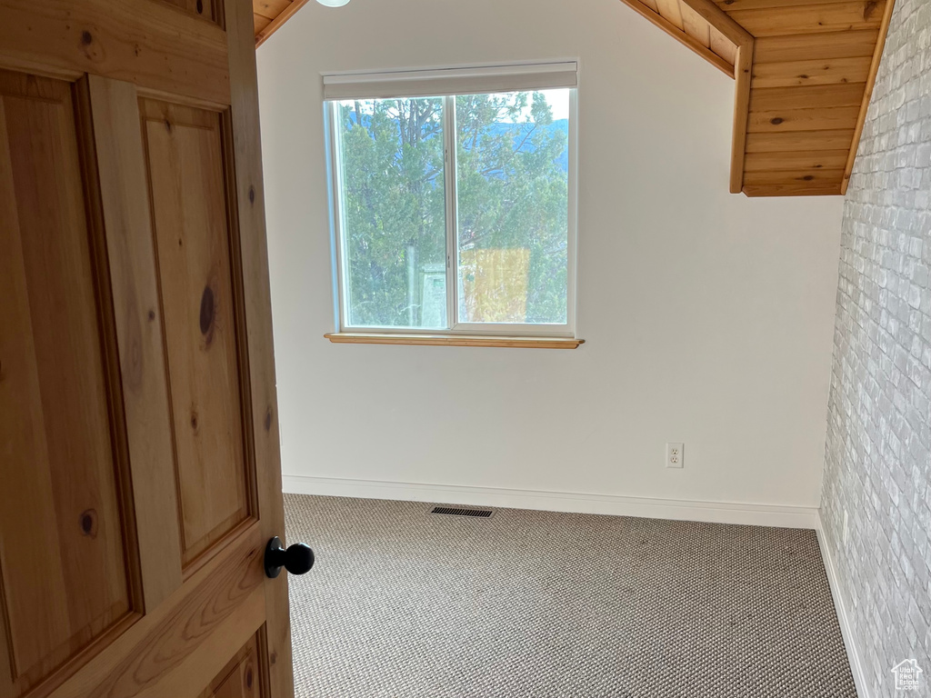 Unfurnished bedroom with carpet flooring and baseboards