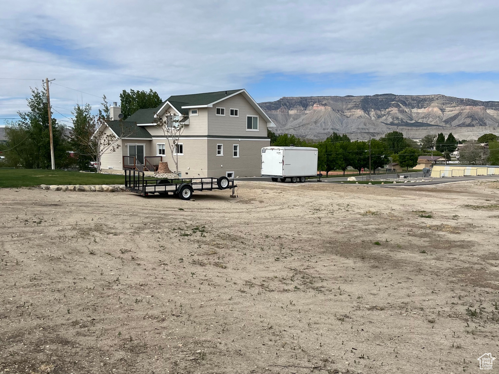 Back of house with a mountain view and a chimney